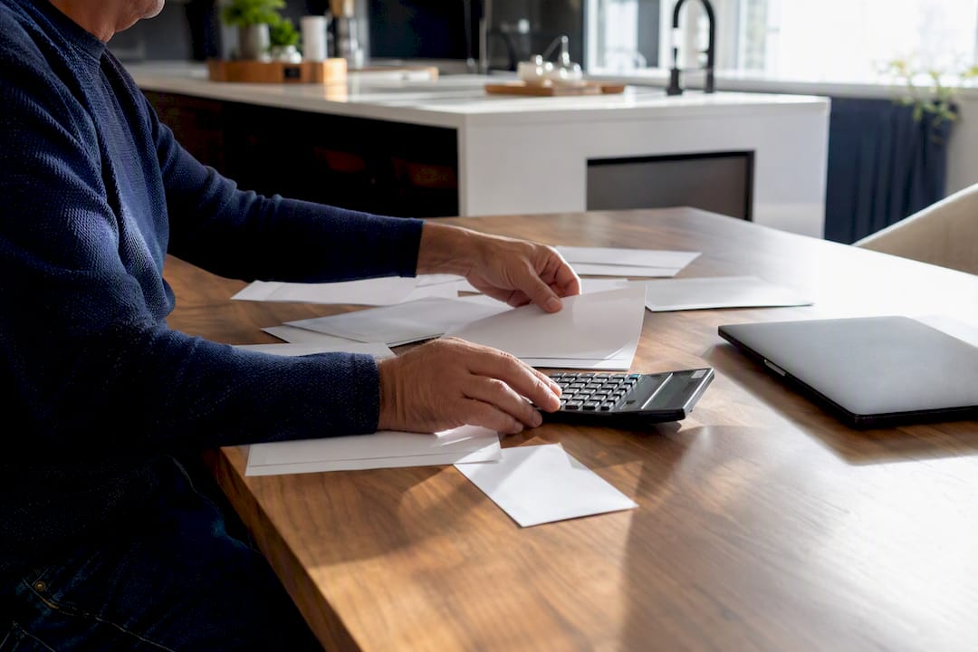Hands organizing mortgage income documents
