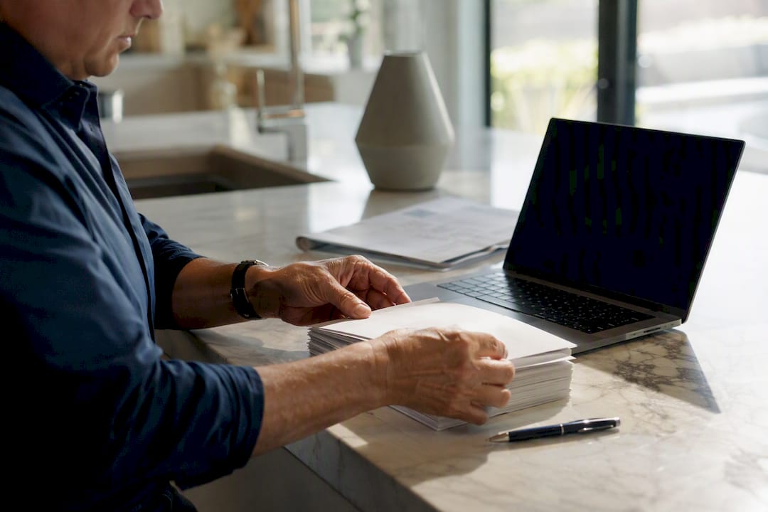 Hands handling mortgage escrow envelopes